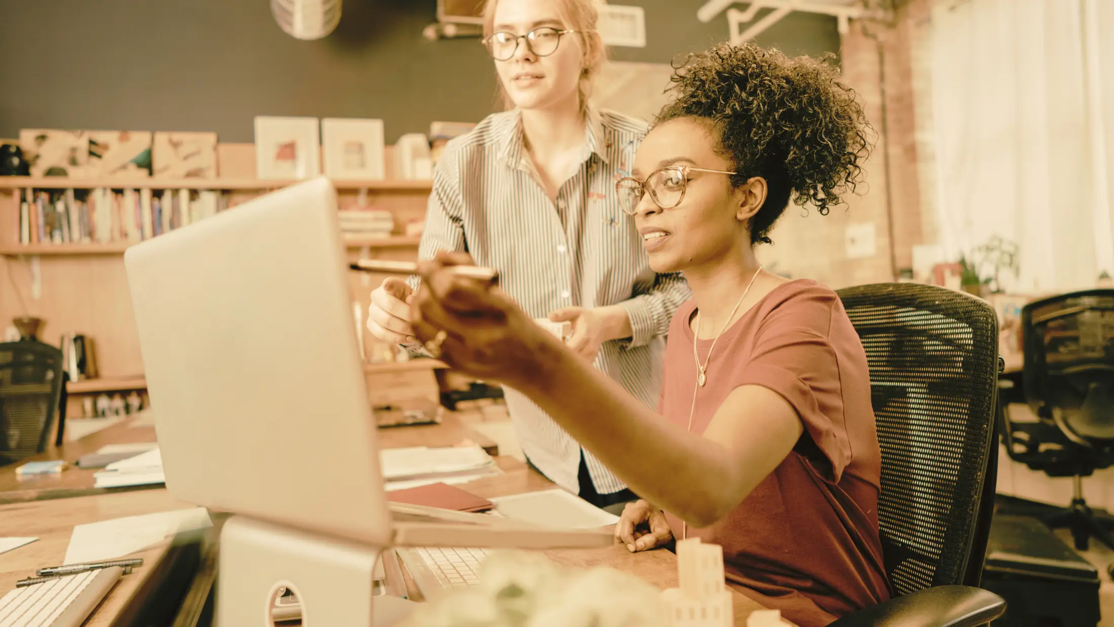 A staff member delegating content editing to another team member. 